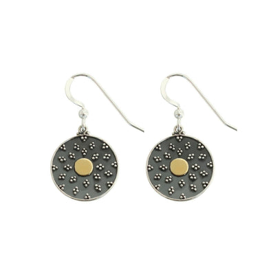 Round sterling silver earring with bronze circle in middle  on white background