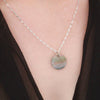 Paua & Black Mother of Pearl double-sided necklace on neck.