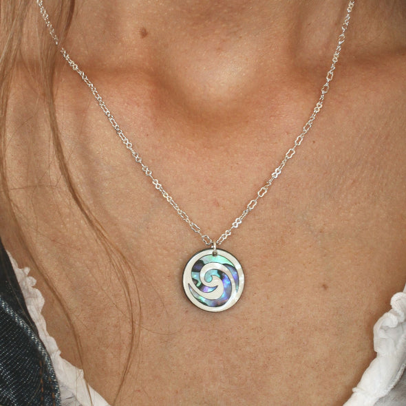 Paua Koru Necklace on the neck