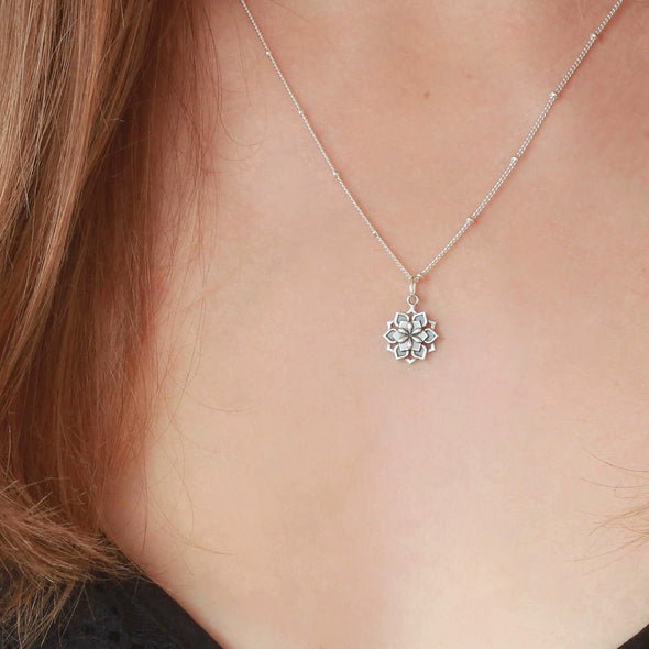 Small Sterling Silver Lotus flower necklace on neck