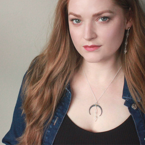Model wearing Crescent shape necklace with Clear quartz crystal gemstone, and gemstone earrings