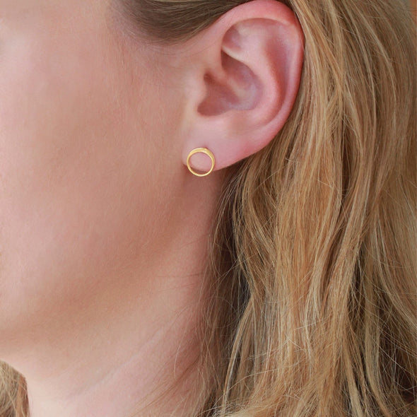 Gold Circle Stud earrings on earlobe