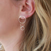 3 Sterling Silver circle stud earrings on model earlobe