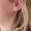 Gold Circles 3 drop stud earrings on model earlobe