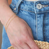 Gold chain bracelets on wrist