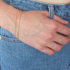 Gold chain bracelets on wrist