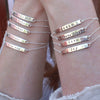Sterling silver hand-stamped bracelets on wrists