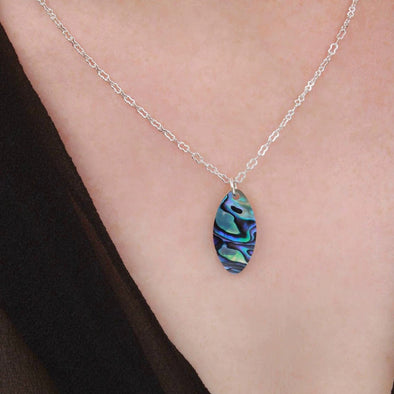 Paua & White Mussel oval shell necklace on neck.