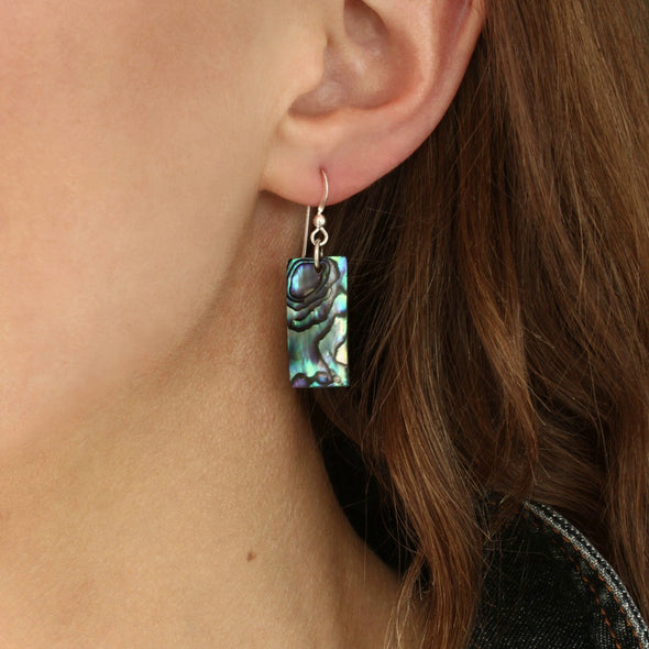 Rectangle Paua earrings on the ear