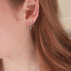 2 Sterling silver hoop earrings on model ear