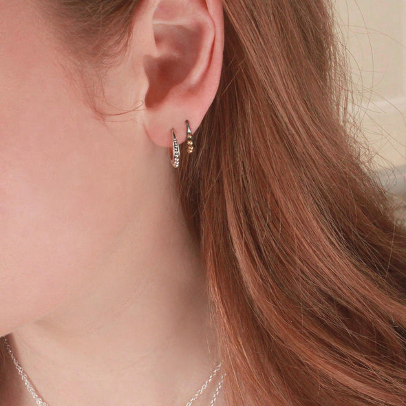 2 Sterling silver hoop earrings on model ear