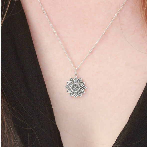 Sterling silver mandala 'abundance' necklace on neck.