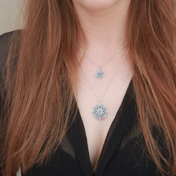 Sterling silver layered Mandala necklaces on neck.